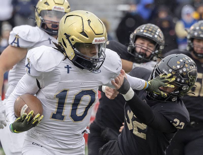 Althoff Catholic’s Dierre Hill Jr. stiff arms Lena-Winslow's Jimmy Goebel Friday, Nov. 29, 2024, in the class 1A football state final.