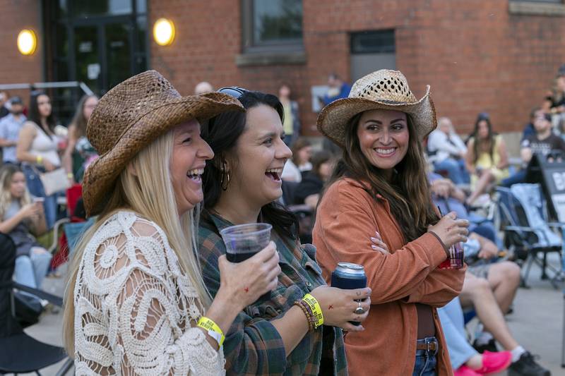 Country music fans Amanda Richardson (left), Desiree Sheridan and Courtney Teller smile and enjoy the night Saturday, May 31, 2025, at the River Country Summer Kickoff 2025 in Dixon.