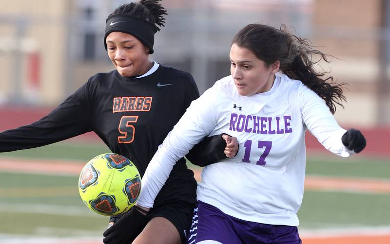 DeKalb's Madison McNeil and Rochelle's Kara Martinez try to get control of the ball during their game Thursday, April 14, 2022, at DeKalb High School.
