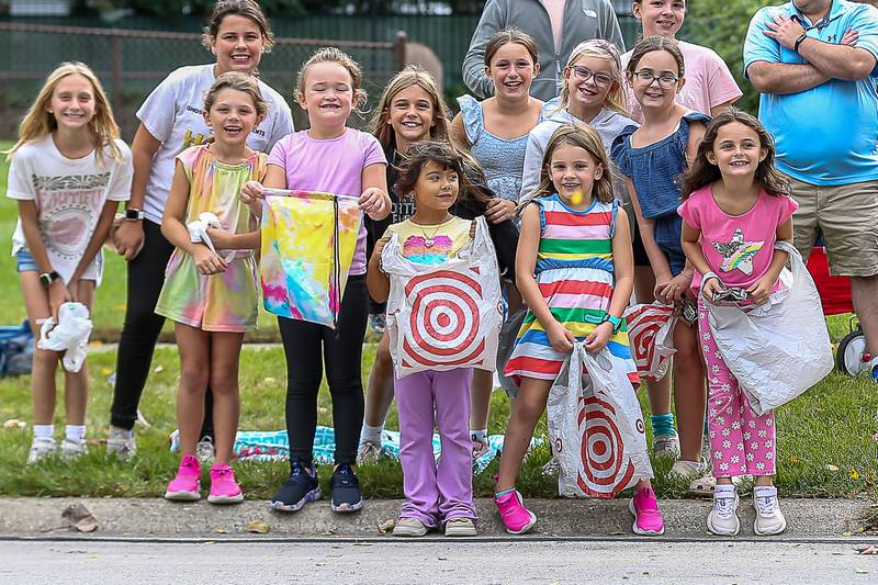 Children are ready with their candy bags at the Downers Grove South Homecoming Parade. Sept 21, 2024 in Downers Grove.