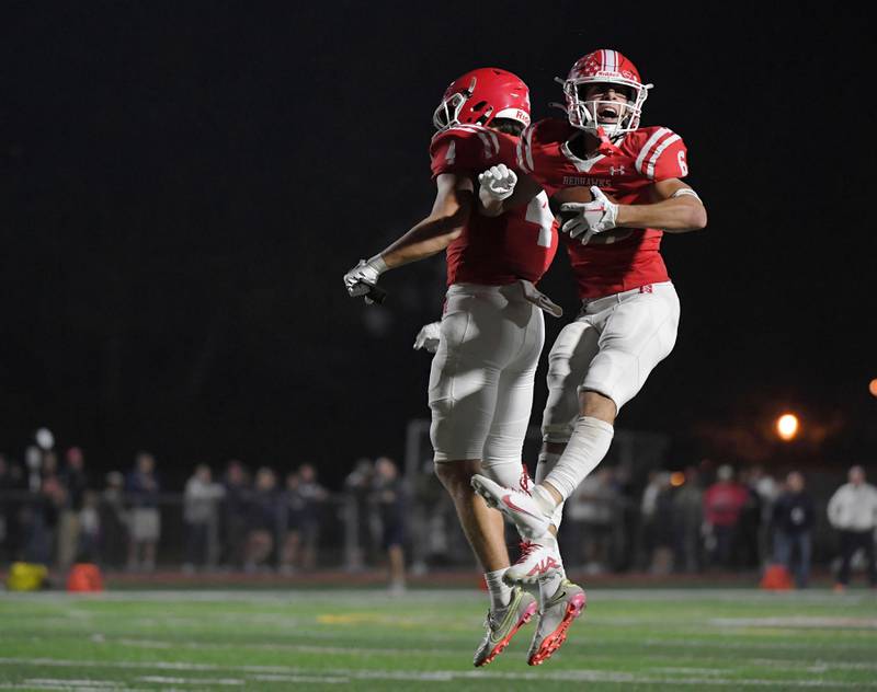Naperville Central’s Christopher Bern celebrates is second touchdown catch against Naperville North with teammate Logan Ellison in a high school football game at North Central College in Naperville on Friday, September 29, 2023.