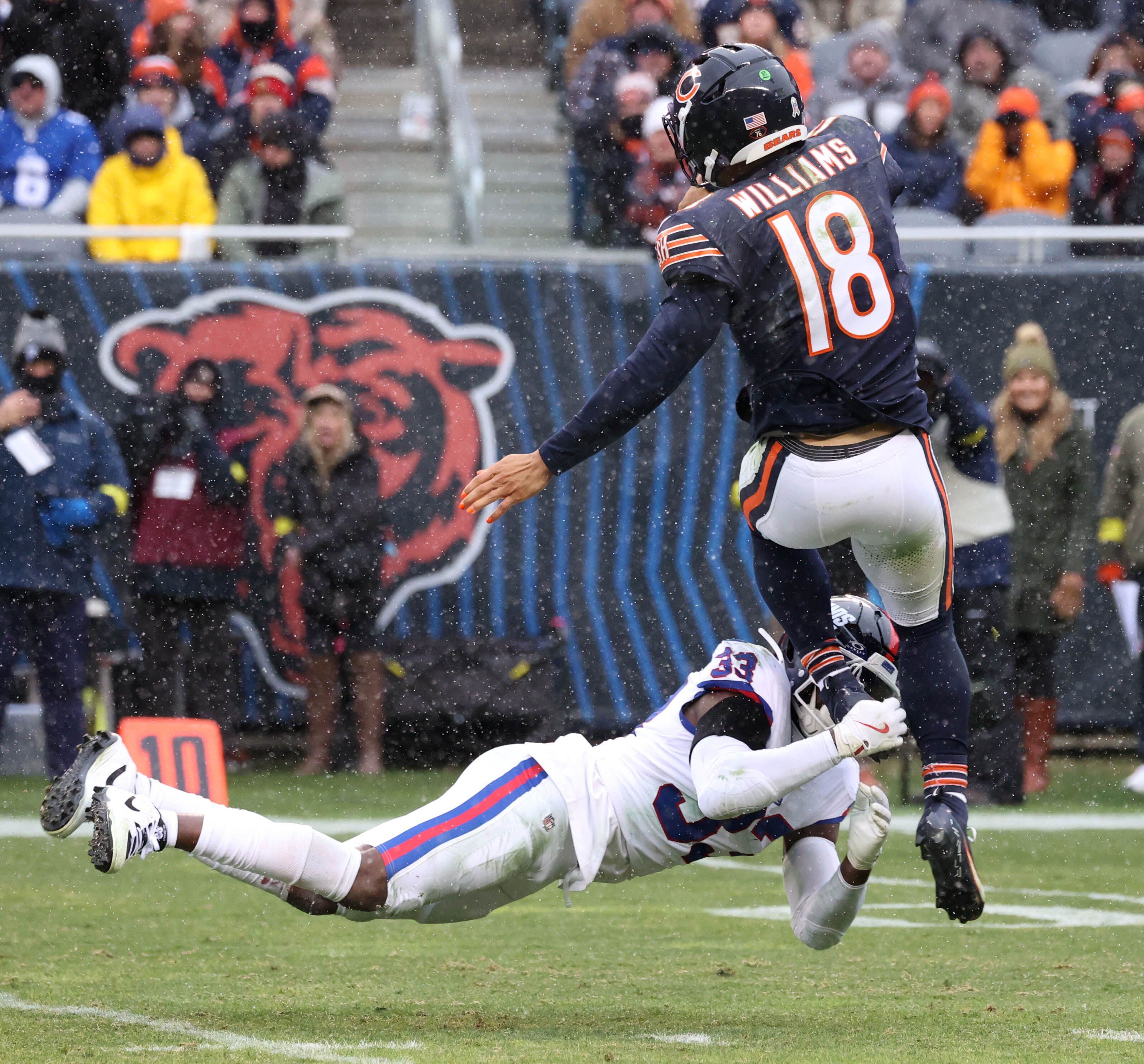Chicago Bears quarterback Caleb Williams gets rid of the ball just ahead of the hit by New York Giants linebacker Demetrius Flannigan-Fowles Sunday, Nov. 9, 2025, during their game at Soldier Field in Chicago.
