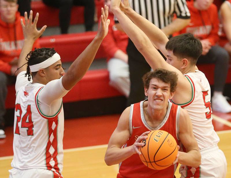 Streator's Matt Williamson sneaks in between L-P defenders Marion Persich and teammate Erick Sotelo during the Dean Riley Shootin' The Rock Thanksgiving Tournament on Monday, Nov. 25, 2024 in Kingman Gym at Ottawa High School.