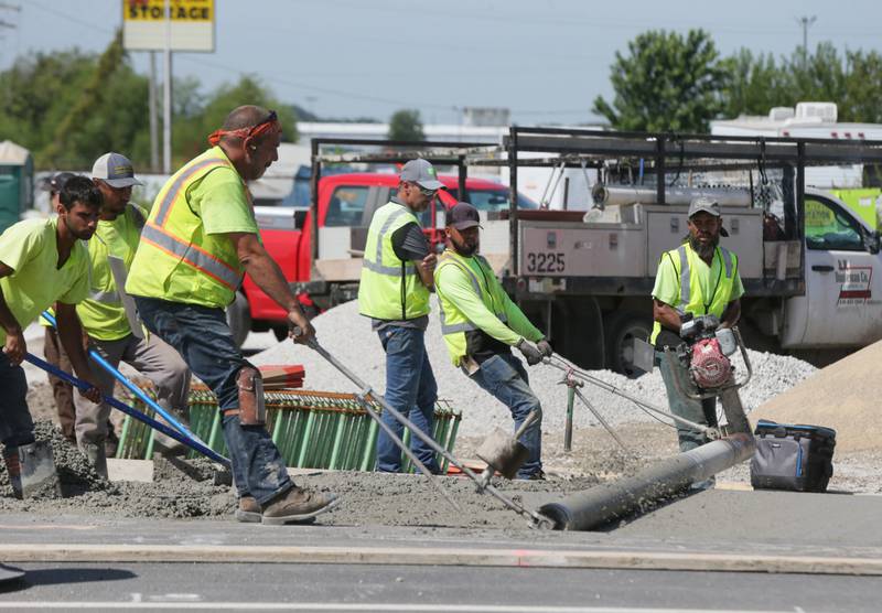 Workers pave the roundabout at the intersection of 178 and U.S. Route 6 on Thursday, Sept. 1, 2022 in Utica.