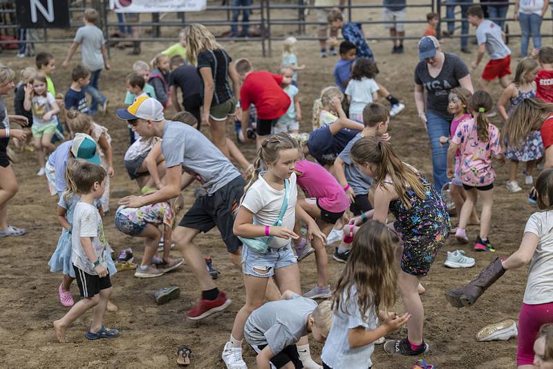 Kids scramble to find and put on their shoes during a race at the rodeo Wednesday, August 14, 2024, at the Whiteside County Fair in Morrison.