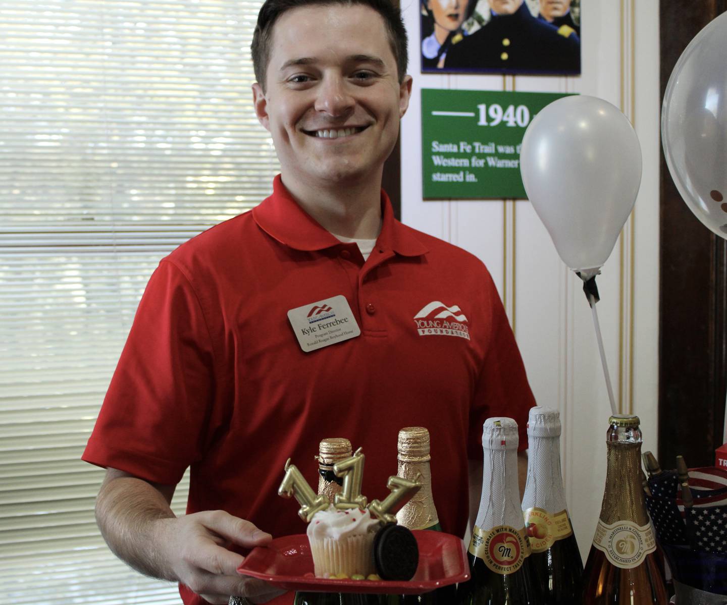 Kyle Ferrebee, the Young America's Foundation program director for the Ronald Reagan Boyhood Home, shows off the 111th birthday cupcake and refreshments being offered to visitors on Saturday.