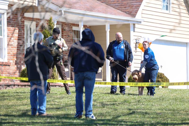 Will County Animal Protection Services staff help retrieve a pet dog from a home in the 3400 block of Norway Trail in Crete Township as the Will County Sheriff's Department investigates a triple homicide on Monday, March 23, 2026.