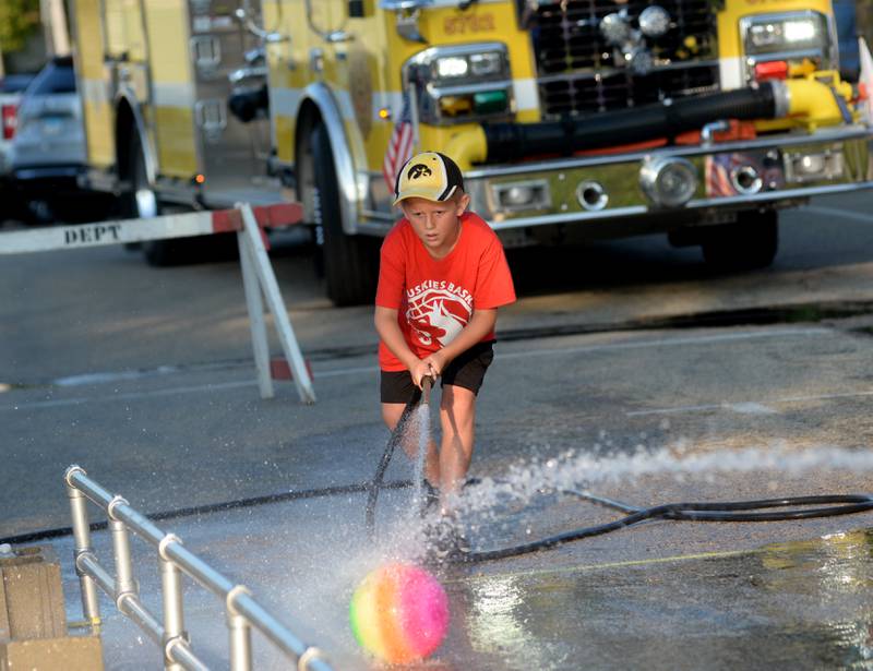 Warren Rosko, 6, of Davis Junction competes in the kids' water fight at Let Freedom Ring on Monday. The event was organized by the Mt. Morris Fire Department.