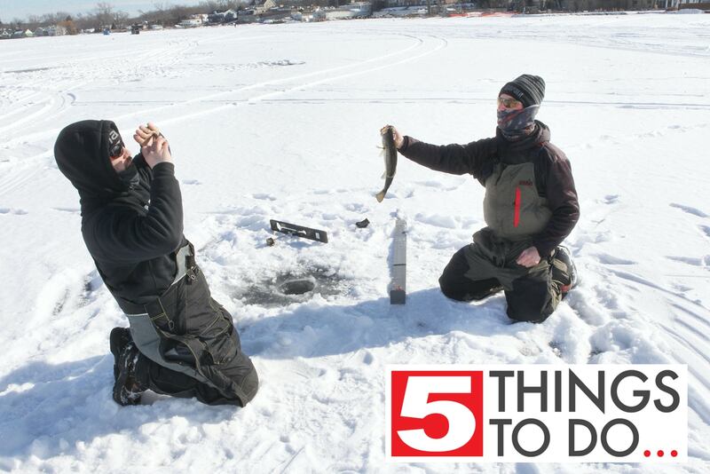 Ethan Kappler, of Fox Lake, takes a picture of Damen Byrne, of McHenry, with the largemouth bass he caught during the LVVA Ice Fishing Derby on Bangs Lake in Wauconda. Another ice fishing derby is set for Sunday in Lake in the Hills.