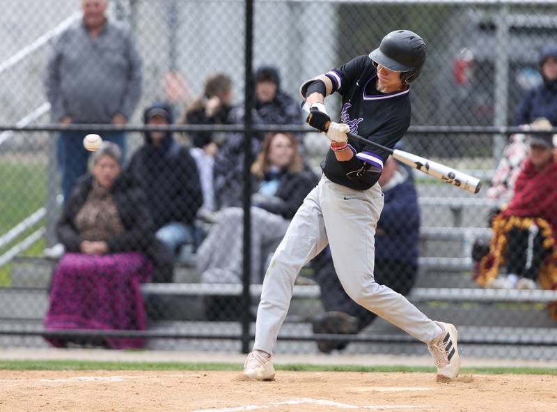 Downers Grove North's Jude Warwick (13) swings at his homerun pitch during the varsity baseball game between Downers Grove South and Downers Grove North in Downers Grove on Saturday, April 29, 2023.