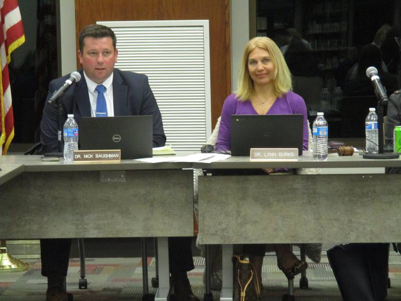 Yorkville School Board President Lynn Burks, right, presides over the  March 28, 2022 board meeting. At left is Associate Superintendent of Learning & Instruction Nick Baughman. (Mark Foster -- mfoster@shawmedia.com)