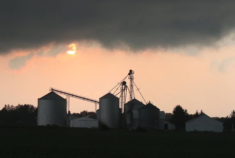 The sun peeks out from behind storm clouds over a farm on Bethany Road in Sycamore Monday Aug. 9, 2021, after severe weather rolled through the area. Several funnel clouds and tornadoes were reported in DeKalb County Monday afternoon.