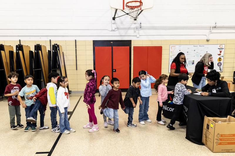 Kindergarteners at T. E. Culbertson Elementary School line-up to receive a free winter coat from Nicor, Gas in collaboration with Operation Warm, on Nov. 7, 2025.