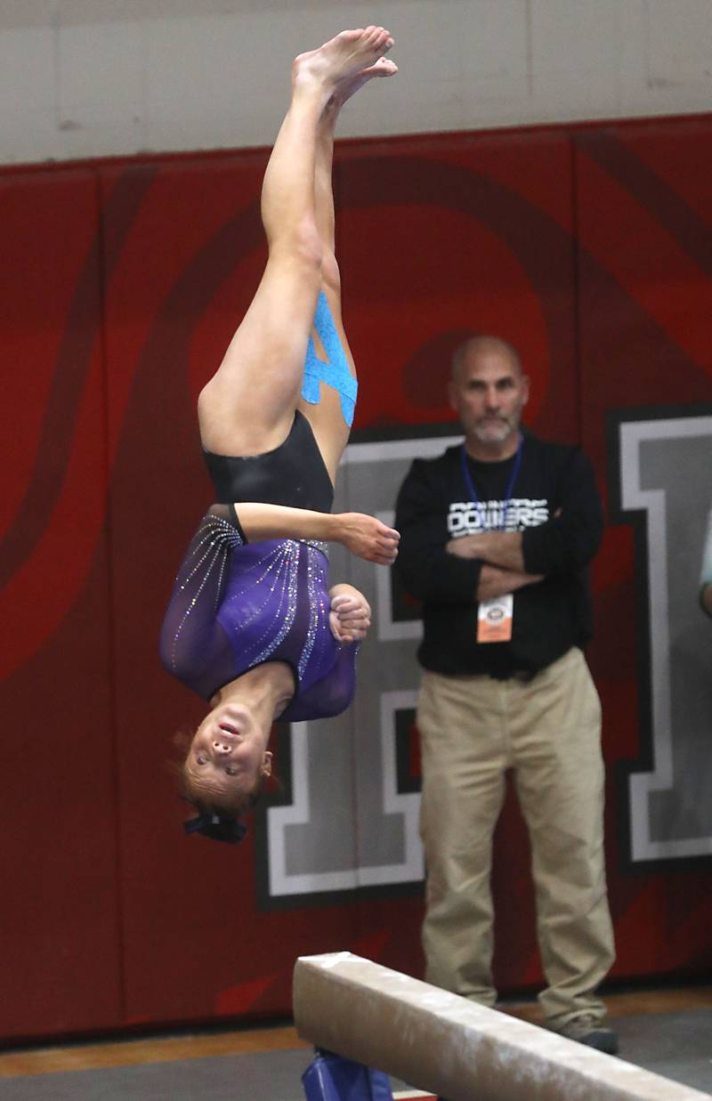 Downers Grove South’s Caroline Phillip competes in the preliminary round of the balance beam on Friday, Feb. 20, 2026, during the IHSA Girls State Final Gymnastics Meet at Palatine High School.