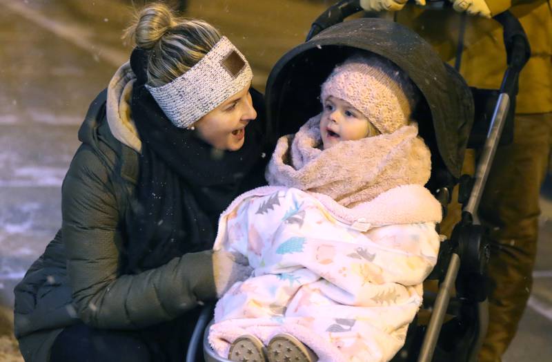 Brecklynn Saffron, 2, and her mom Lori, from Sycamore, enjoy watching the dancers in the window of a downtown store Friday, Nov. 18, 2022, during the Sycamore Chamber of Commerce's annual Moonlight Magic event in downtown Sycamore.
