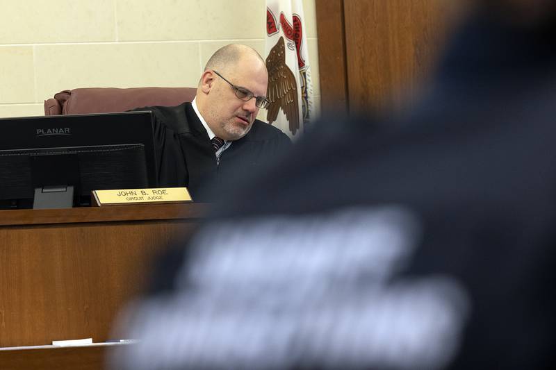 Ogle County Assistant Public Defender Michael O'Brien speaks with client Jonathon Gounaris during a hearing at the Judicial Center in Oregon on Monday, March 17, 2025.