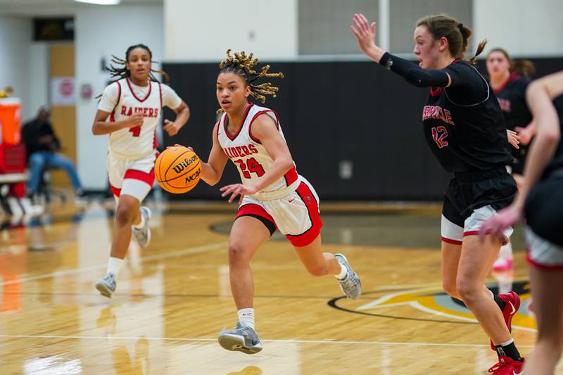 Bolingbrook's Amya Simmons (24) brings the ball up the court against Yorkville's Elaine Gussman (12) during a Class 4A Metea Valley Regional final basketball game at Metea Valley High School in Aurora on Friday, Feb. 21, 2025.