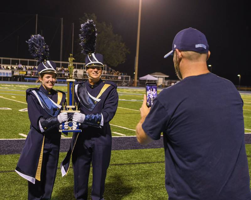 Lemont drum major Eva Casenzo, left, and Luke Rupert pose for a photo after Lemont marching band was named best percussion, best general effect and first place in the AA division of the Downers Grove South Marching Mustangs Music Bowl on Saturday Oct. 5, 2024, held at Downers Grove South High School football field.