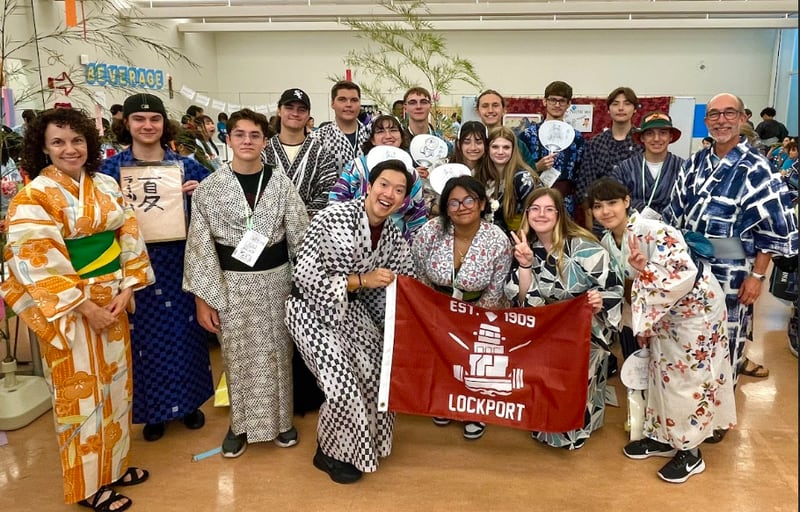 Japanese teacher Karla Button and Superintendent Robert McBride pose with LTHS students on their trip to Japan in traditional clothes gifted to them by their hosts.