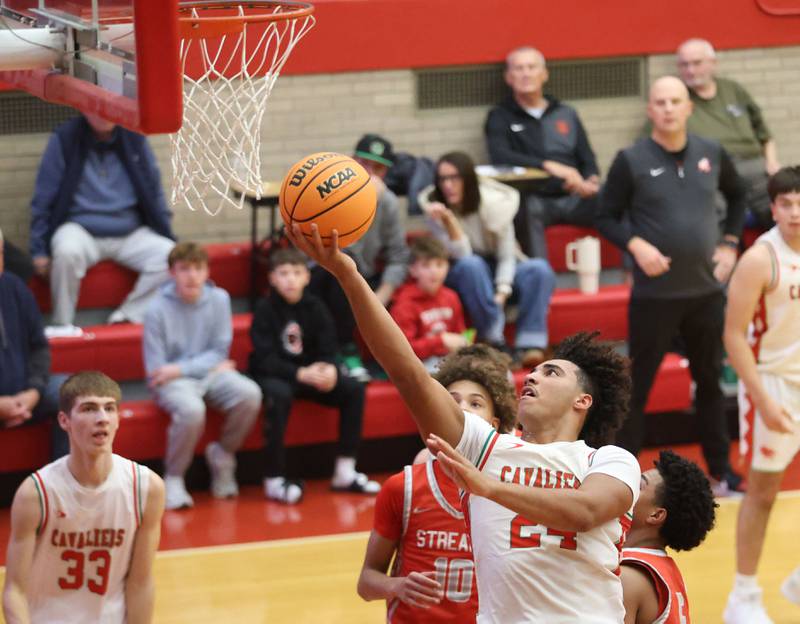 L-P's Marion Persich cuts inside the lane to score over Streator's Christian Bruton during the Dean Riley Shootin' The Rock Thanksgiving Tournament on Monday Nov. 24, 2025 in Kingman Gymnasium at Ottawa High School.