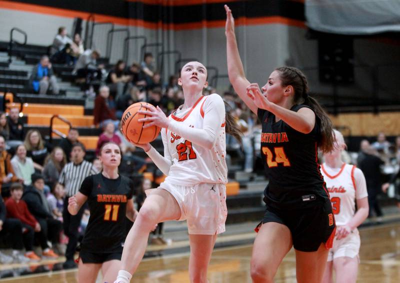 St. Charles East’s Sofia O’Sullivan goes up for a shot defended by Batavia’s Hallie Crane during a game on Wednesday, Jan. 8, 2025 in St. Charles.