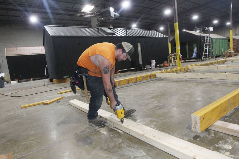 Jack Beucher, of Silver Lake, Wis., framer, works on framing the foundation for a Milla Long, the largest unit prefabricated tiny home with 456 sq. ft., in the factory at PrefabPads LLC in Waukegan on July 17th, 2023.
Image by Candace H. Johnson for Shaw Local News Network