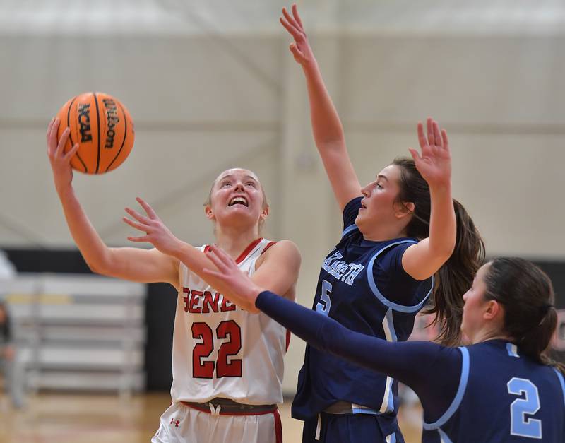 Benet’s Bridget Rifenburg (22) goes to the basket as Nazareth’s Sophia Towne and Samantha Austin (2) defend during a game on January 28, 2026 at Benet Academy in Lisle.