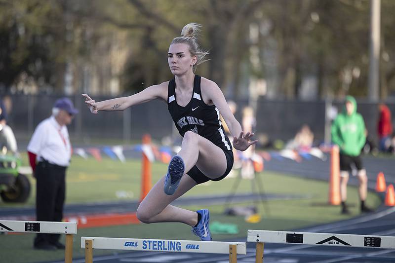 Rock Falls’ Amara Thomas clears a hurdle in the 100 girls shuttle hurdle relays Thursday, April 27, 2023  at the Sterling Night Relays.