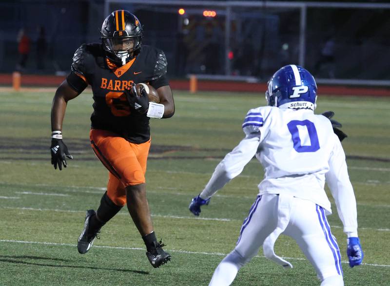 DeKalb's Travis Moore looks to get by Phillips' Rahshard Jordan Friday, Sept. 5, 2025, during their game at DeKalb High School.