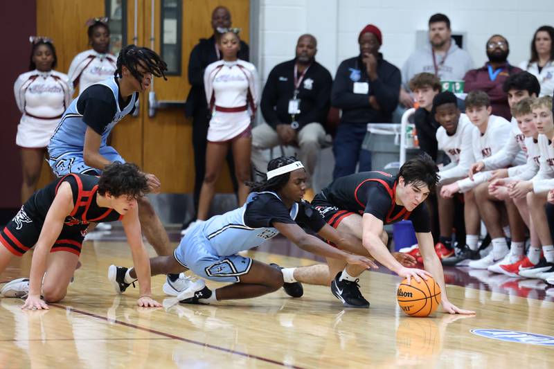 Kankakee's Cedric Terrell III dives for a loose ball against Lincoln-Way Central's Nolan Morrill during the Kays' 54-50 victory over Lincoln-Way Central in the 75th Kankakee Holiday Tournament maroon bracket championship on Sunday, Dec. 28, 2025.