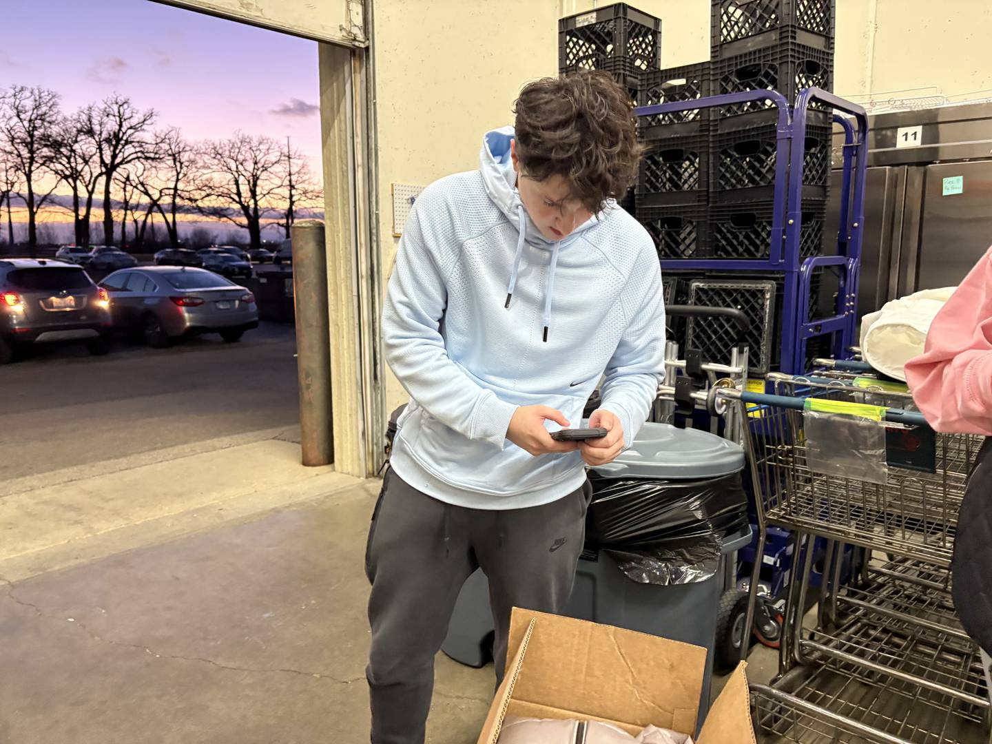 Huntley High School student Nolan Laird takes a photo of a donation he dropped off at Grafton Food Pantry Dec. 11, 2024.
