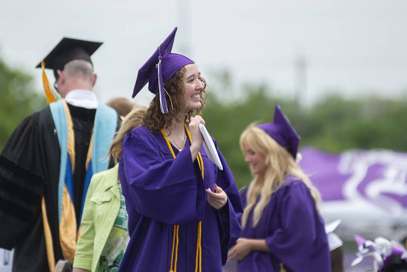 Shea Lahey smiles and presents her diploma Sunday during Dixon High School’s graduation.
