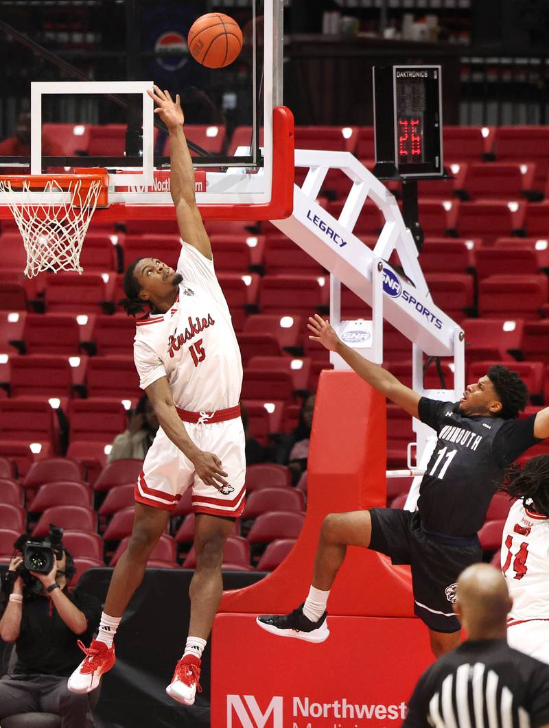 Northern Illinois' Ethan Butler tries to block the shot of Monmouth's Aric Demings during their game Tuesday, Nov. 12, 2024, in the Convocation Center at NIU in DeKalb.