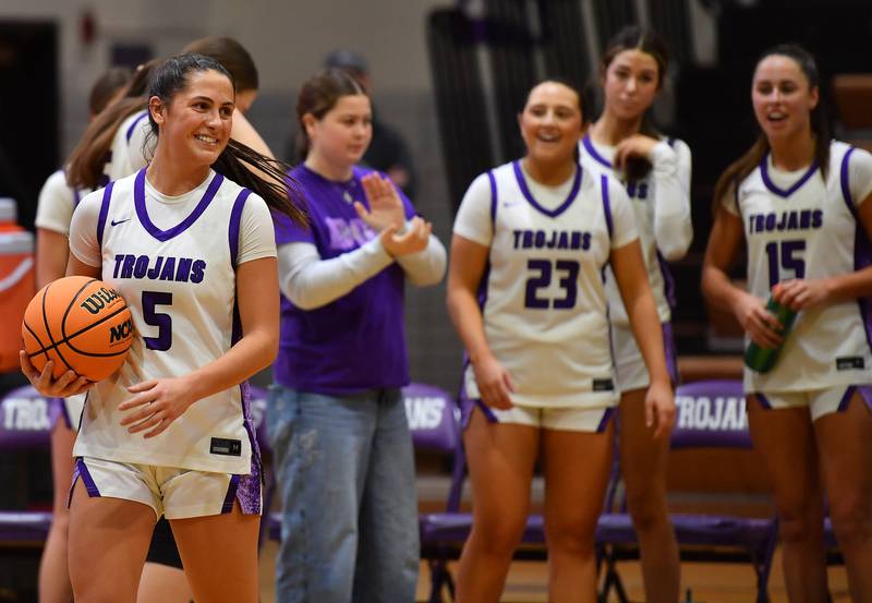 Downers Grove North’s Campbell Thulin brings out the game ball for photos after a game against Downers Grove South where she surpassed 1,000 career points on December 20, 2025 at Downers Grove North High School in Downers Grove.