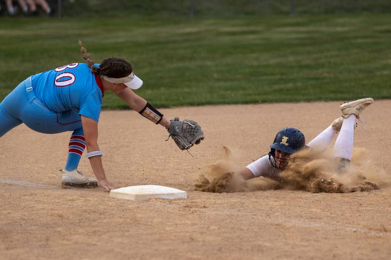 Ava Zdenovec (22) of Lemont slides into third base as Aubrey Sullivan (30) of Ottawa attempts to tag her out on Tuesday, June 3, 2025 at Ottawa High School in Ottawa.