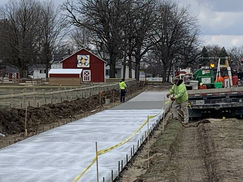 Kankakee Valley Construction workers pour concrete on the first day of installing the 10-foot-wide sidewalk at Perry Farm Park along Kennedy Drive in Bradley on Wednesday, March 26, 2025.