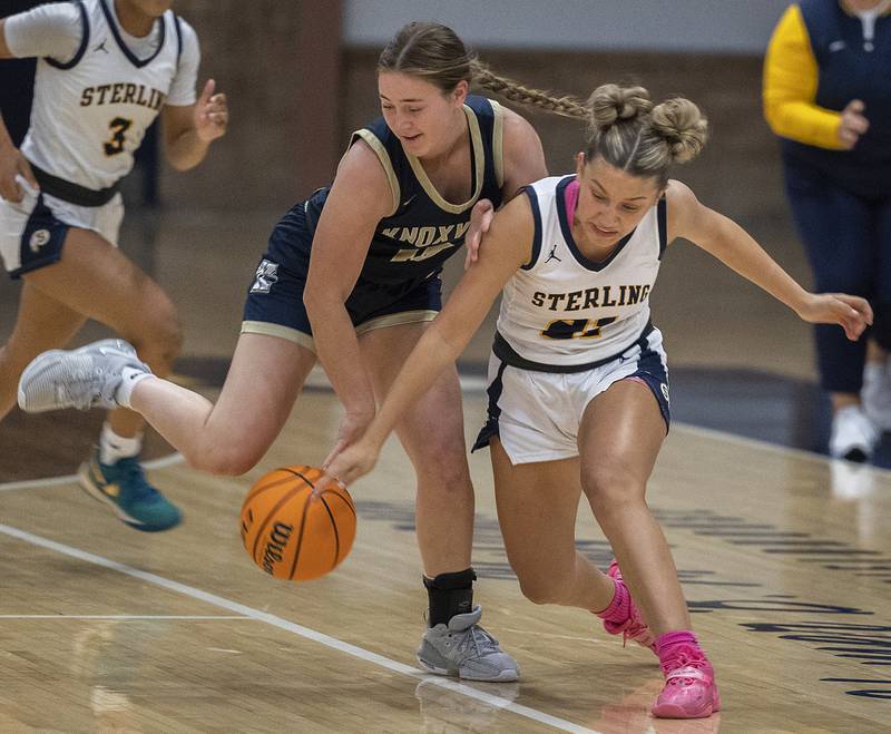 Sterling’s Jae James gets tangled up with Knoxville’s Lexi Harshbarger Tuesday, Nov. 19, 2024, at Sterling High School.