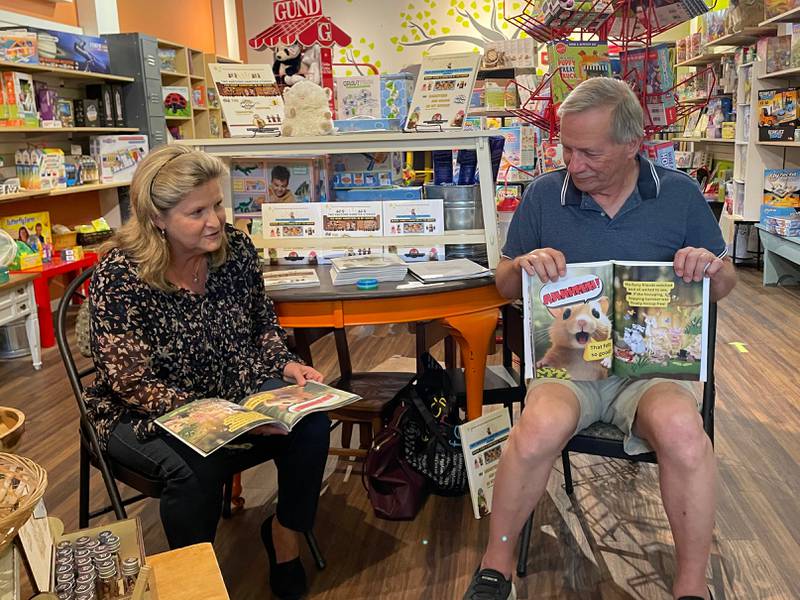 Jeanne Sommerfield, left, and author Mark Sommerfield, read from his book Two Awesome Hamsters Stories Vol. 1, earlier this summer at Marvin's Toy Store in Crystal Lake.