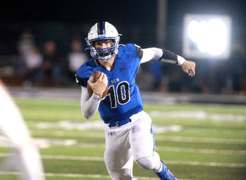 St. Charles North quarterback Ethan Plumb keeps the ball during a game against Geneva in St. Charles on Friday, Oct. 20, 2023.