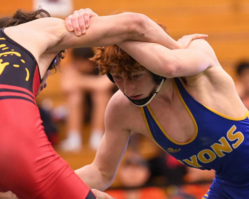 Griff Powell of Lyons Township go head to head with Batavia  Ino Garcia during the regional title match where Griff took second in the 120 weight class on Saturday Feb. 3, 2024, held at Glenbard West High School.