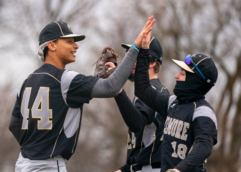 Sycamore's Tommy Townsend (44) high fives Addison Peck (18) after a five inning 10 - 0 victory over Plano at Plano High School on Monday, April 4, 2022.