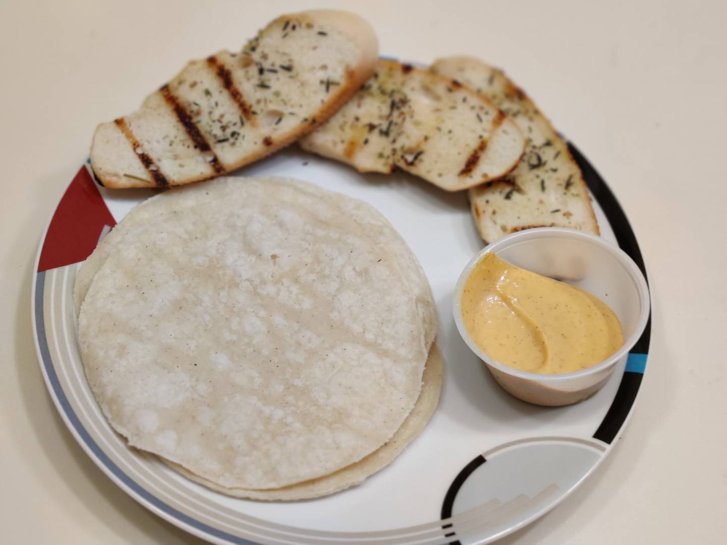 Tortillas and grilled, herb-spiced bread slices from Altiro Latin Fusion in Geneva.