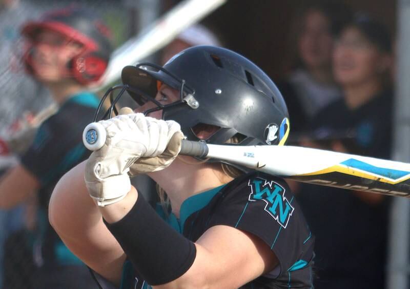 Woodstock North’s Casey Vermett watches the flight of her second of two home runs against Jacobs in varsity softball at Algonquin Friday night.