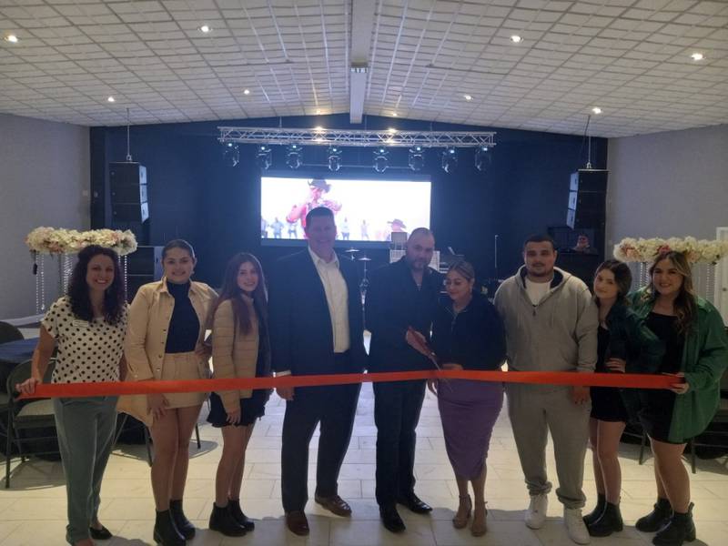 The Morris Theater owners Julio Gomez and Maria Novoa cut the ribbon during a ceremonial ribbon cutting with the Grundy County Chamber and Morris Mayor Chris Brown last month. The old theater in downtown Morris is now an event venue.