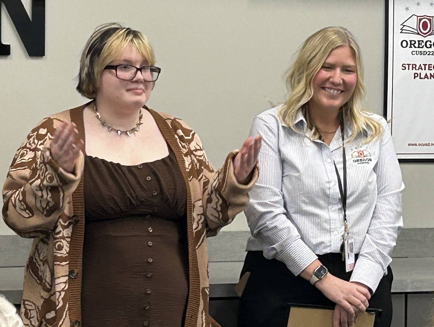 Oregon High School student Kerrie Diaz (left) was recognized for illustrating a children's book, "Get Out of Here Piggies!", during the Oregon School Board meeting on Wednesday, April 22, 2025.