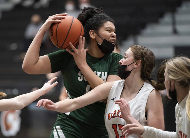 Crystal Lake South's Nicole Molgado pushes through McHenry defender Alyssa Franklin during their game on Tuesday, January 11, 2022 in McHenry.