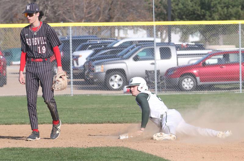 St. Bede's Gus Burr steals second base on a pass ball as Hall's Noah Plym watches the play on Monday, March 31, 2025 at Schweickert Stadium in Peru.