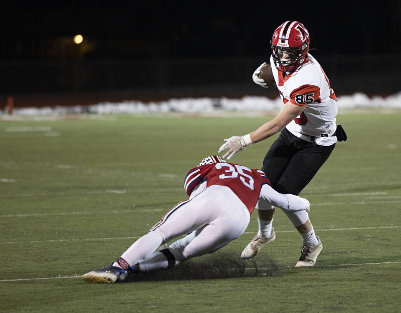 Amboy’s Brennan Blaine is tripped up by West Central’s Parker Meldrum Friday, Nov. 18, 2022 in the 8-man championship football game.