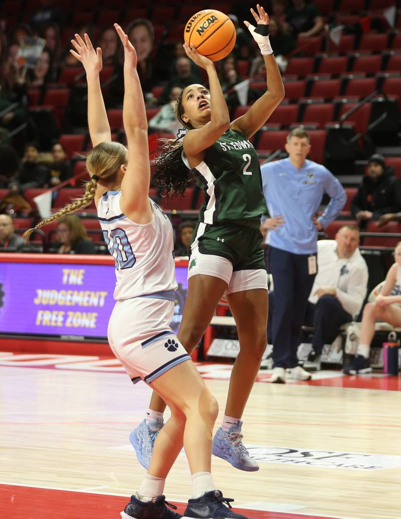 St. Edward's Savannah Lynch eyes the hoop as Cissna Park's Ava Henrichs defends during the Class 1A third place game on Friday, March 7, 2025 at CEFCU Arena in Normal.