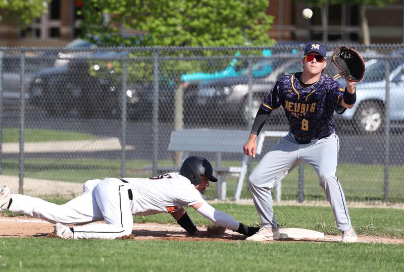 DeKalb’s Paul Kakoliris slides back safely into first as Neuqua Valley's Will Zalabak makes the catch during their game Tuesday, May 7, 2024, at DeKalb High School.